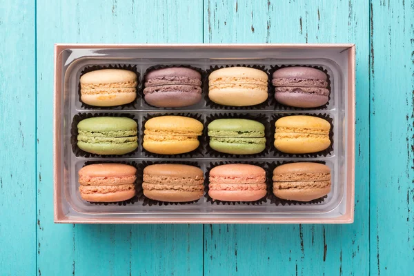 Studio shoot of colorful macaroons on a blue wood background with copy space — Stock Photo, Image
