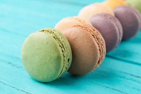 Studio shoot of colorful macaroons on a blue wood background — Stock Photo, Image