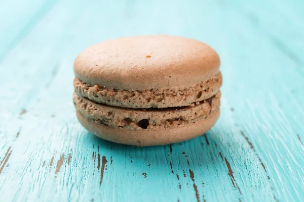 Pink macaroon on a blue wood background — Stock Photo, Image