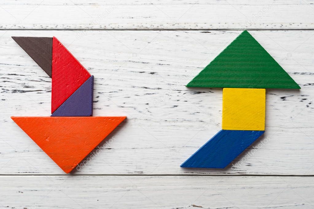 wooden tangram in two arrow shapes one is up and the other is down