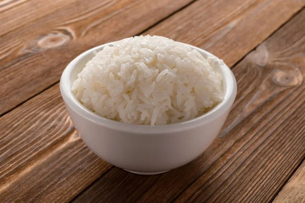 Tazón Lleno Arroz Sobre Fondo Madera — Foto de Stock