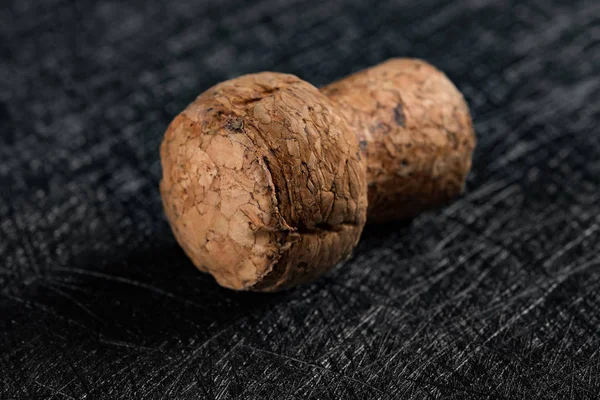 studio shoot of wooden cork from champagne bottle on a dark backrgound