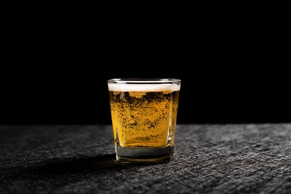 cup of fresh beer on a dark background