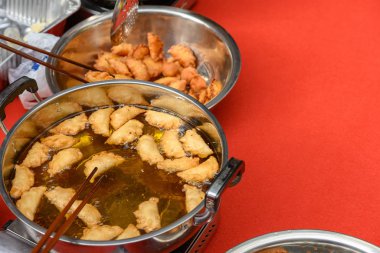 Çin Yeni Yılı için geleneksel Yau Kok Zai 'yi kızartmak ya da Çin Yeni Yılı için yakınlarda çiğ hamur tatlısı pişirmek.