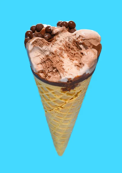 angle view chocolate flavor ice cream cone with a bite on a blue background