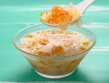 Kaşıkla sağlıklı şeftali sakızı, beyaz mantar ve nilüfer tohumları alınıyor.