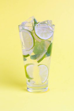 Naneli, limonlu ve sarı arka planda ezilmiş buzlu kokteyl.