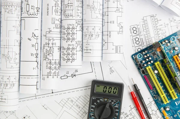 electrical engineering drawings, computer motherboard and digital multimeter