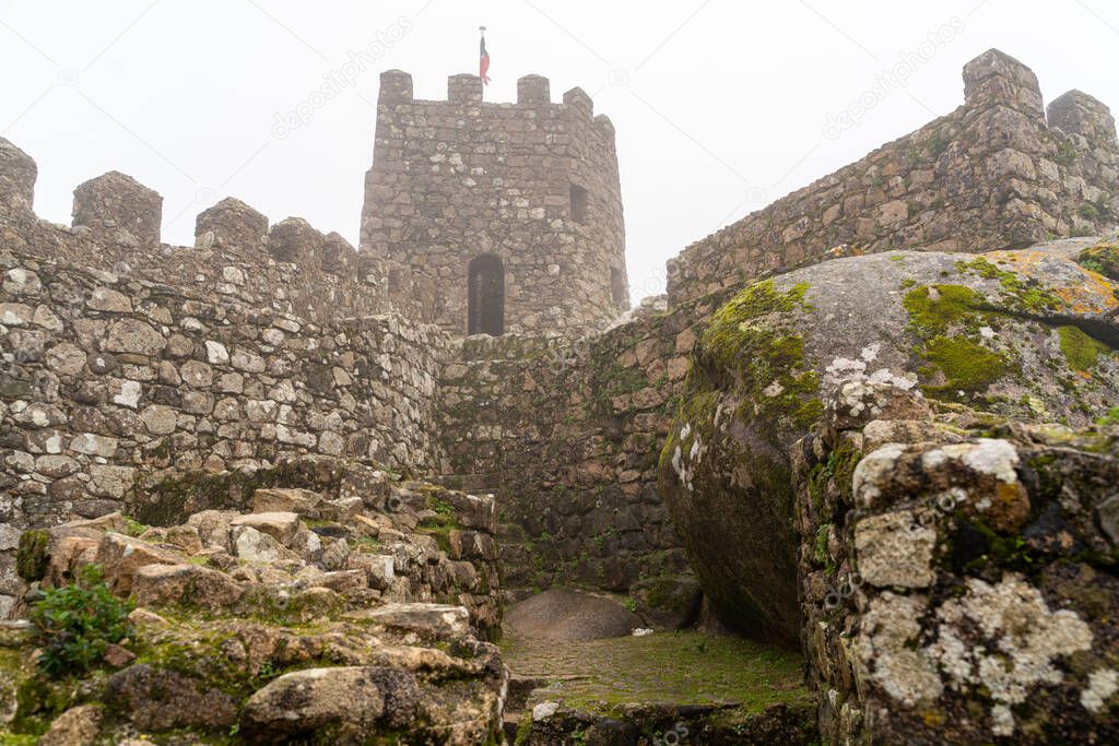 Foggy view of a watchtower at the Moorish Castle in Sintra Portu
