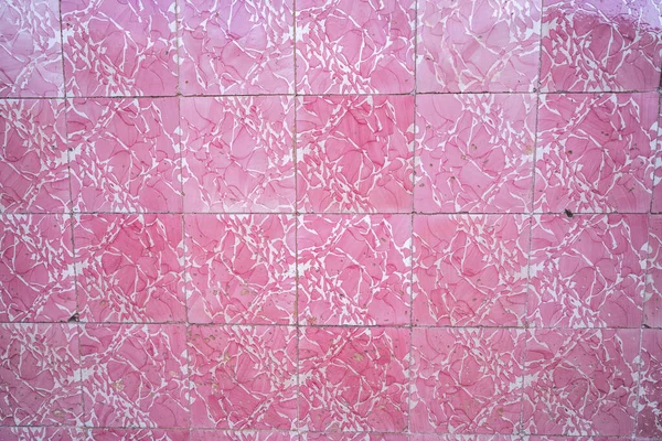 Bright pink tiles on a building wall in Silves, Portugal, tradit