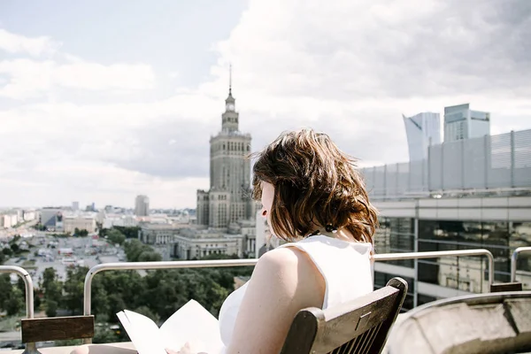 Kız Kültür Sarayı'nın Varşova, bir iş kadını bakan bir kitap okur. Bayan masada oturur, kahve içer ve işten rahatlatır. Ara çalışma. Güzel gün.