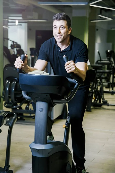 Boy on a stationary bike.