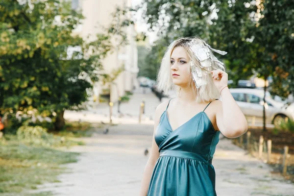 Girl with a haircut. Young woman with pigeons. An early walk of the city's streets. Sunrise in the city.