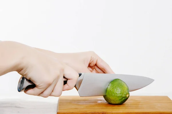 The girl cuts the knife with vegetables and fruits. Vegetables and fruits on the rain. Fruits and vegetables in the cut.