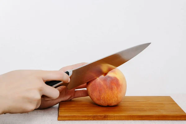 The girl cuts the knife with vegetables and fruits. Vegetables and fruits on the rain. Fruits and vegetables in the cut.