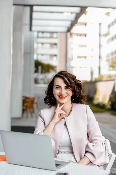 Stylish woman reading a newspaper. Successful girl with a notebook. Business woman. Stylish girl with a notebook. The lady is smiling.