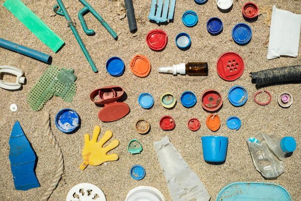 Close up plastic waste on ocean beach. Concept of the problem of pollution of the world ocean by plastic