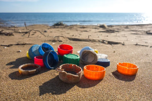 Plastic plugs collected on the beach. Ocean plastic pollution concept.