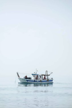 Shrimp boat in the Mediterranean, in front of the coast of Malaga. Picking the typical concha fina Malagas clam (Cytherea chione)