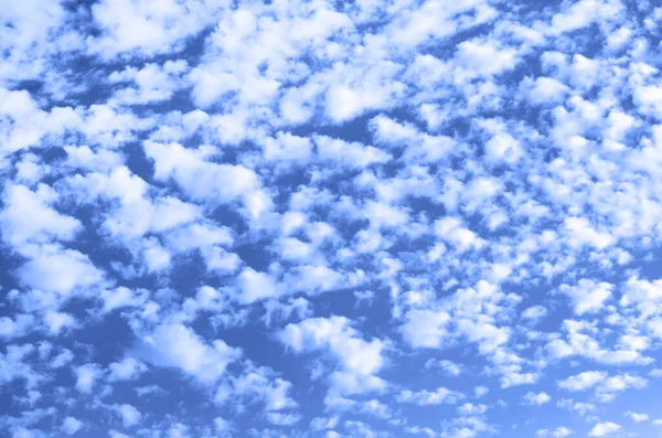 The sky is blue with clouds. Photo tinted blue. — Stock Photo, Image