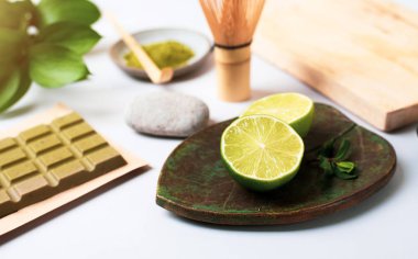 Green chocolate with matcha tea. Still life with green products: lime, matcha tea, green chocolate