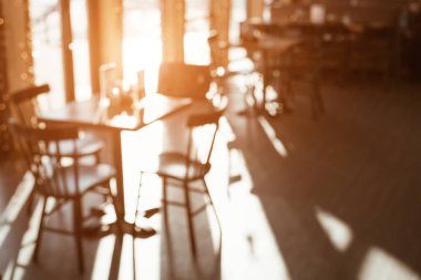 Interior of the cafe with large Windows. Sunny day. Blurred background.