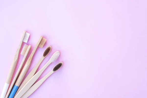 Ecological wooden toothbrushes on a pink background. — Stock Photo, Image