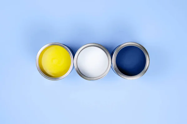 Paint cans on a classic blue background. — Stock Photo, Image