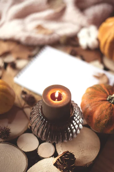 Cozy autumn composition with a candle and a candlestick.