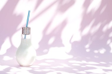 Protein shake in the original vessel with a cocktail tube. 