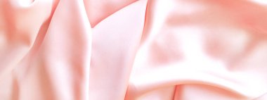 Şeftali rengi saten kumaştan. Metin ve logo için hafif arkaplan.