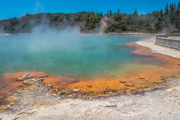 Steaming hot Wai-O-Tapu sulfur pond with odorous fumes, New Zealand. Royalty free stock photo.