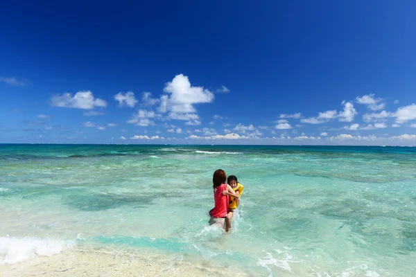 Família brincando na praia — Fotografia de Stock