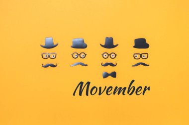 Sarı turuncu renkli Movember için bıyıklı dört yüz