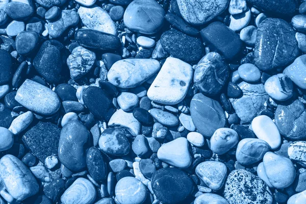 Mavi ıslak çakıl taşları ve deniz kenarında su. — Stok fotoğraf