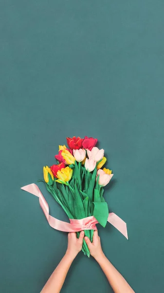 Fresh tulips bouquet on teal background