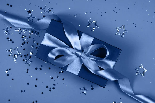 Black gift box on blue background.