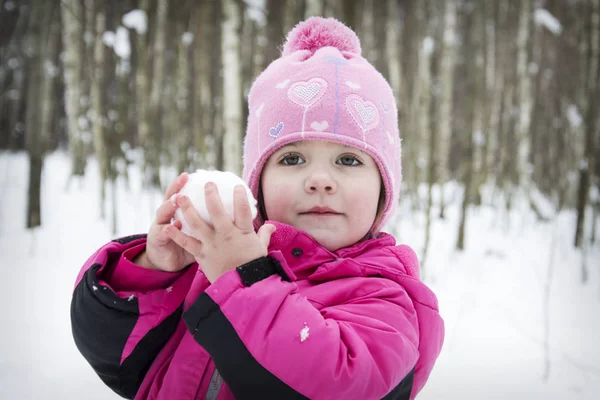 Hiver dans la forêt petite fille tenant une touffe de neige dans leur — Photo