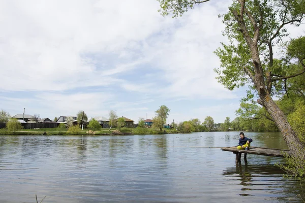 En el verano en el lago cerca de la pesca niño pueblo , — Foto de Stock