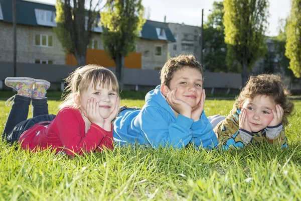 Engraçado menina e um menino sorridente no parque na primavera gr — Fotografia de Stock