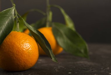 Siyah arka planda turuncu mandalinalar. Metin için bir yer var.