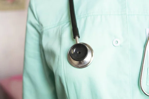 A phonendoscope hangs on the neck of a doctor and paramedic. Health and medicine concept.