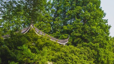 Traditional Chinese architecture among trees near West Lake, Han