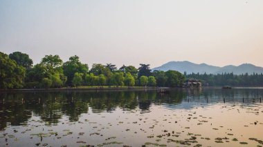 West Lake landscape with reflections in water at sunset, Hangzho