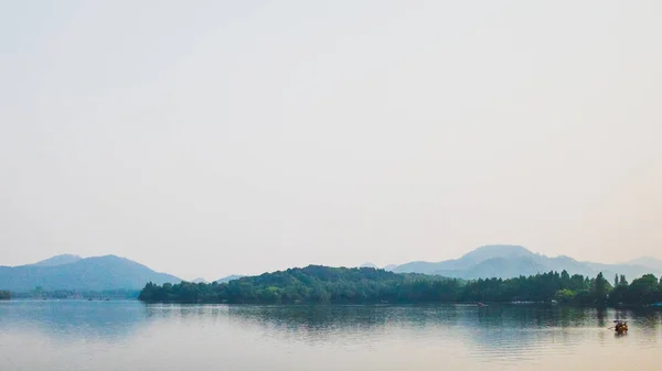 West Lake landscape with reflections in water at sunset, Hangzho