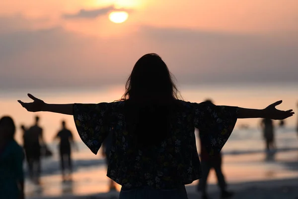 Back view of a young girl silhouette standing and watching sun Royalty Free Stock Images