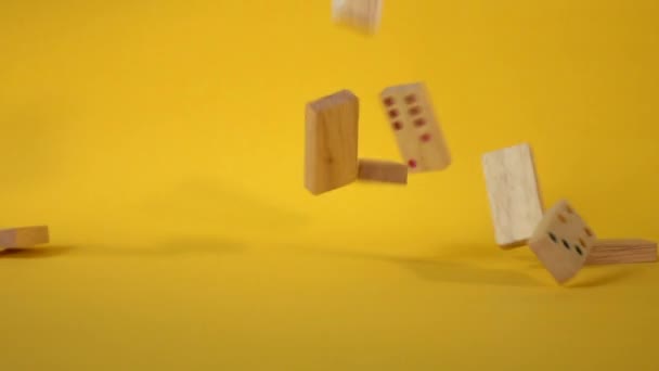 Slow Motion Dominoes Falling Yellow Background — Stock Video