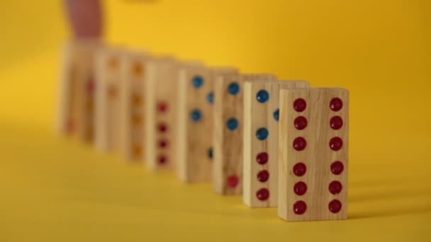 Slow Motion Dominoes Falling Yellow Background — Stock Video