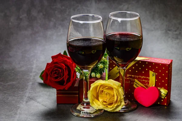 Valentine\'s Day still life: roses, wine and gift boxes