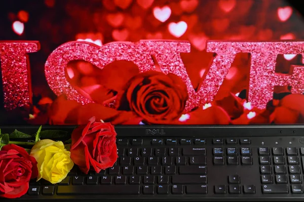 Valentine\'s Day still life: roses, computer and keyboard